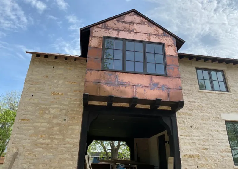 Copper metal panel facade on a stone building for Skylight Installation in Lacy-Lakeview