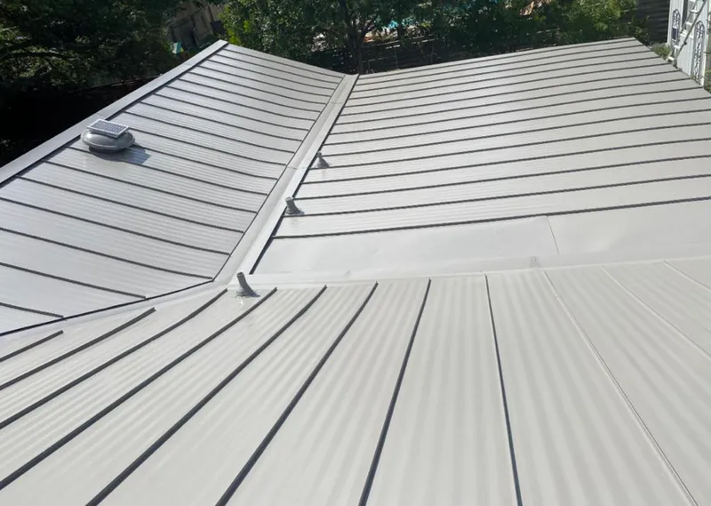 Solar attic fan installed on a metal roof for Roof Ventilation in Lacy-Lakeview